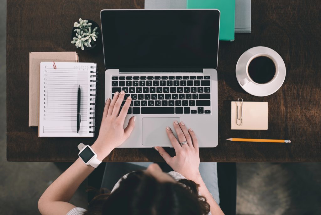 Overhead view of woman using laptop